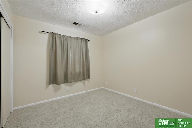 5143 S 126th Plz Unit 22, Omaha, NE 68137 - carpeted spare room featuring a textured ceiling and baseboards