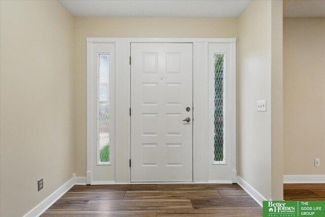 5143 S 126th Plz Unit 22, Omaha, NE 68137 - foyer with dark wood finished floors and baseboards