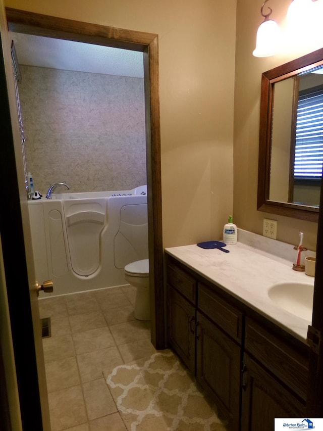 1304 S 4th Ave, Beatrice, NE 68310 - bathroom featuring a bath, vanity, tile patterned flooring, and toilet