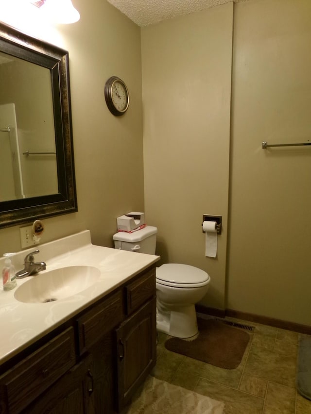 1304 S 4th Ave, Beatrice, NE 68310 - full bathroom featuring vanity, toilet, and a textured ceiling