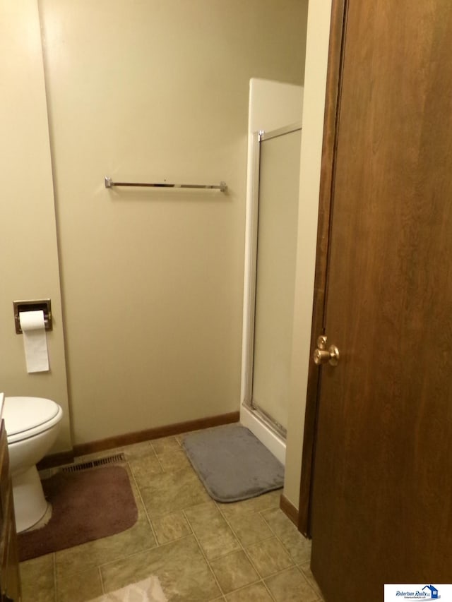 1304 S 4th Ave, Beatrice, NE 68310 - full bath with a shower stall, toilet, baseboards, and tile patterned floors