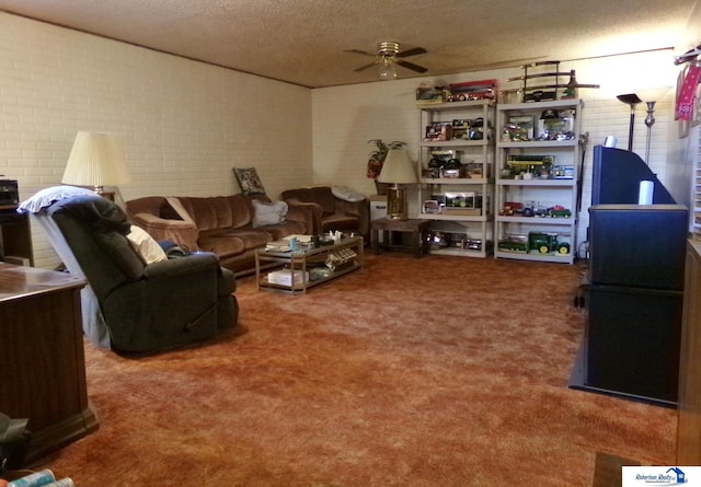 1304 S 4th Ave, Beatrice, NE 68310 - living room featuring a textured ceiling, ceiling fan, carpet flooring, and brick wall