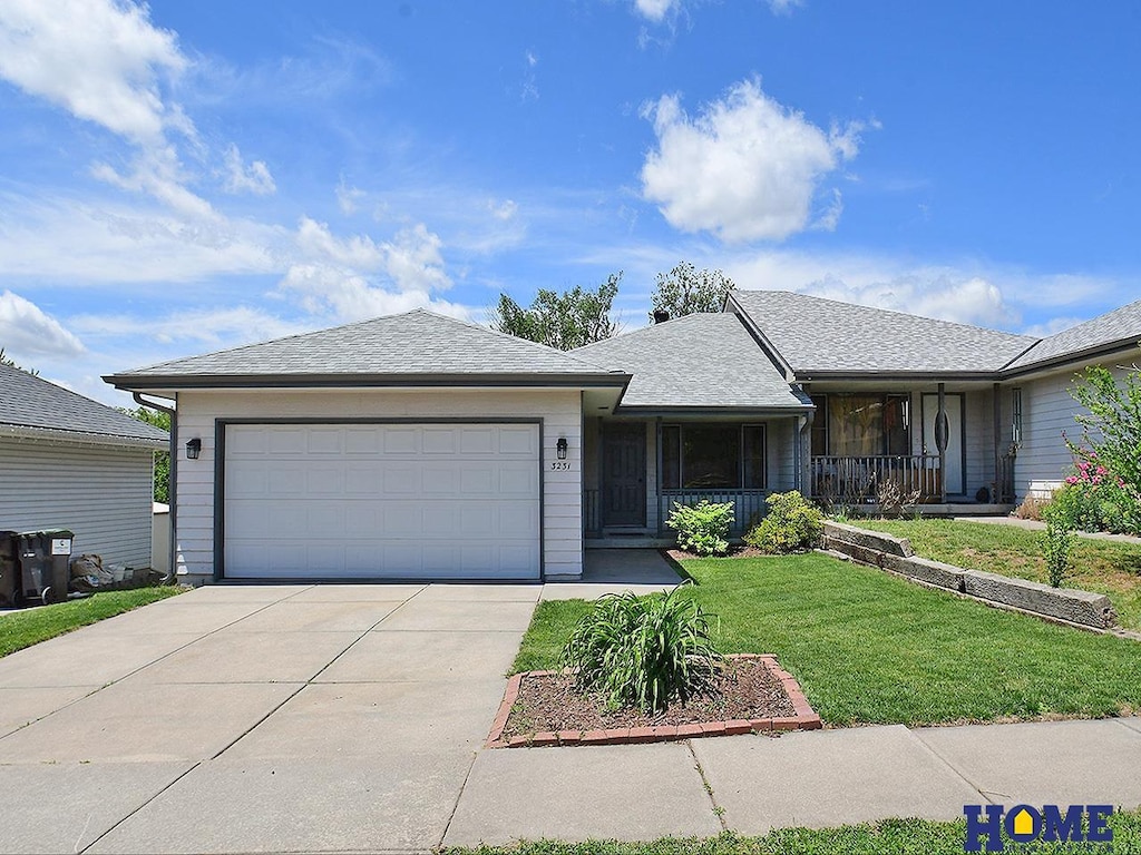 3231 Mickaela Ln, Lincoln, NE 68521 - ranch-style home featuring driveway, a front lawn, a garage, and a porch