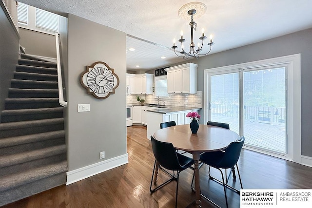 3120 N 205th St, Omaha, NE 68022 - dining space with dark wood-style floors, stairway, baseboards, a chandelier, and recessed lighting