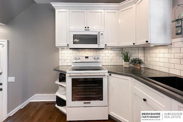 3120 N 205th St, Omaha, NE 68022 - kitchen with white appliances, backsplash, dark countertops, and white cabinets