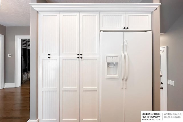 3120 N 205th St, Omaha, NE 68022 - detailed view of white refrigerator with ice dispenser, wood finished floors, and baseboards