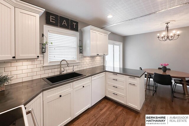 3120 N 205th St, Omaha, NE 68022 - kitchen featuring dishwasher, a sink, a chandelier, dark countertops, and dark wood finished floors