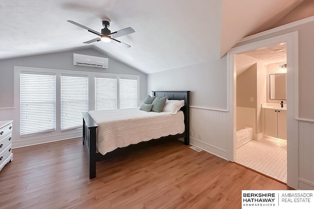 3120 N 205th St, Omaha, NE 68022 - bedroom with a wall mounted air conditioner, vaulted ceiling, light wood finished floors, wainscoting, and ceiling fan