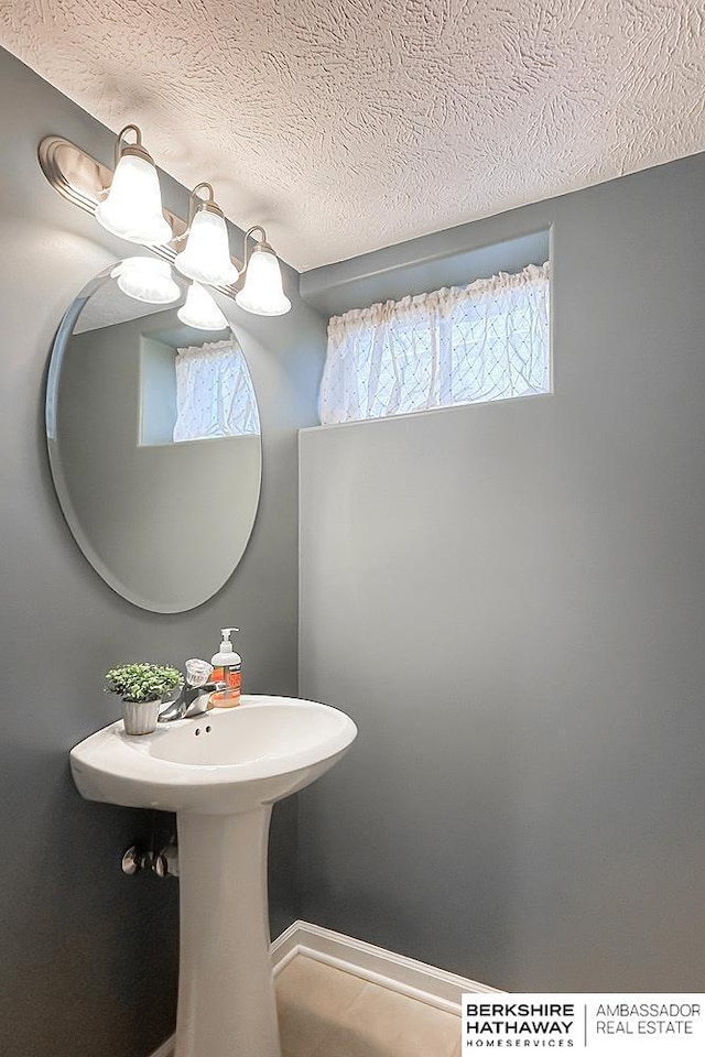 3120 N 205th St, Omaha, NE 68022 - bathroom featuring healthy amount of natural light, a textured ceiling, and a chandelier
