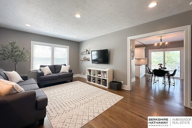 3120 N 205th St, Omaha, NE 68022 - living room featuring a chandelier, dark wood-style floors, a textured ceiling, baseboards, and recessed lighting