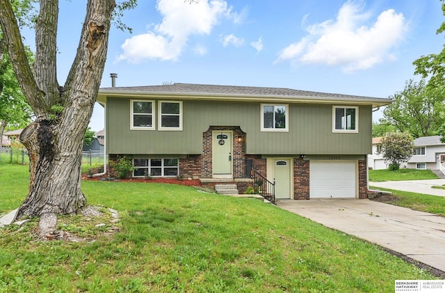 12956 Grand Ave, Omaha, NE 68164 - raised ranch with brick siding, concrete driveway, and a garage