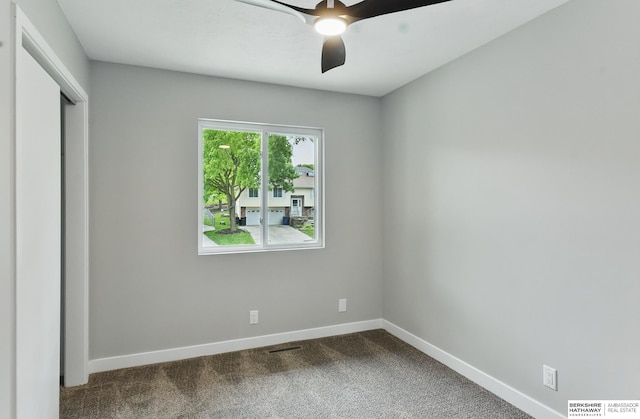 12956 Grand Ave, Omaha, NE 68164 - unfurnished bedroom featuring baseboards, dark colored carpet, a closet, and a ceiling fan