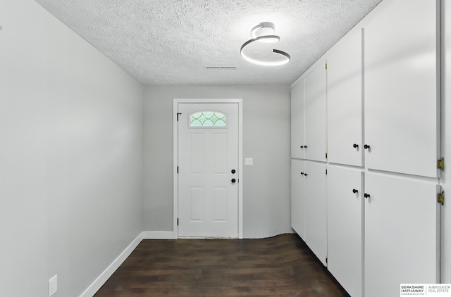 12956 Grand Ave, Omaha, NE 68164 - foyer entrance with a textured ceiling, dark wood-type flooring, and baseboards