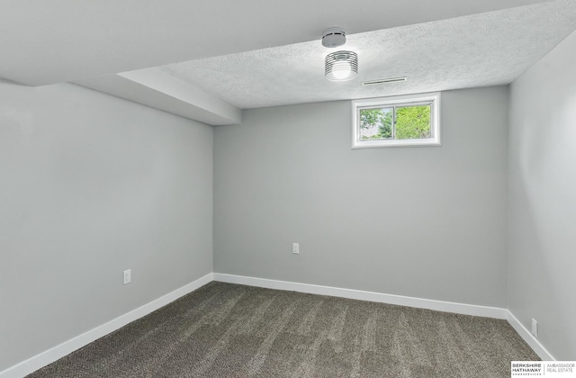 12956 Grand Ave, Omaha, NE 68164 - unfurnished room featuring a textured ceiling, dark colored carpet, and baseboards