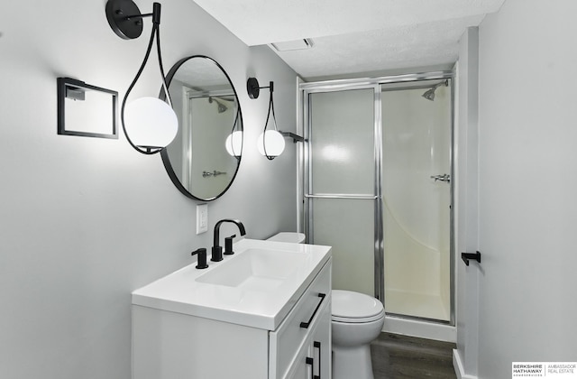 12956 Grand Ave, Omaha, NE 68164 - full bath featuring wood finished floors, vanity, a stall shower, and toilet