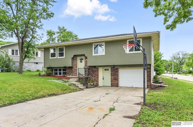 12956 Grand Ave, Omaha, NE 68164 - split foyer home with an attached garage, a front lawn, brick siding, and driveway
