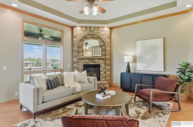 211 Longwood Dr, Papillion, NE 68133 - living area featuring a ceiling fan, a raised ceiling, crown molding, light wood-type flooring, and baseboards