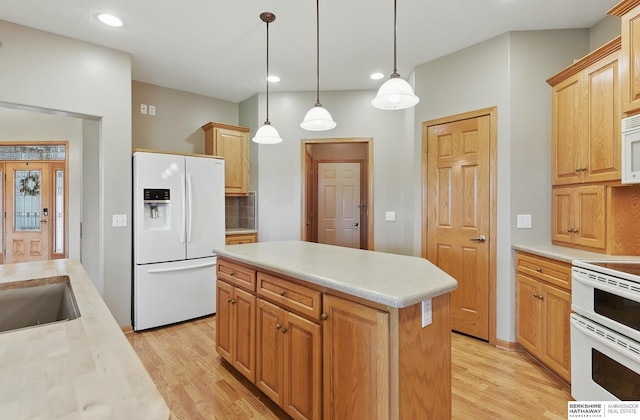 211 Longwood Dr, Papillion, NE 68133 - kitchen with white appliances, light wood-type flooring, light countertops, a kitchen island, and recessed lighting