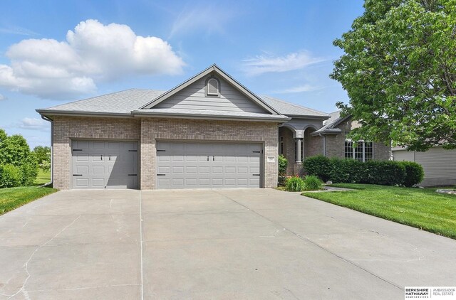 211 Longwood Dr, Papillion, NE 68133 - single story home with an attached garage, driveway, brick siding, and a front lawn