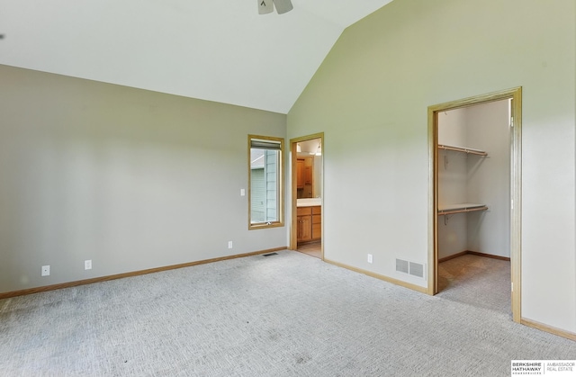 211 Longwood Dr, Papillion, NE 68133 - unfurnished bedroom with light colored carpet, a spacious closet, baseboards, ensuite bathroom, and high vaulted ceiling