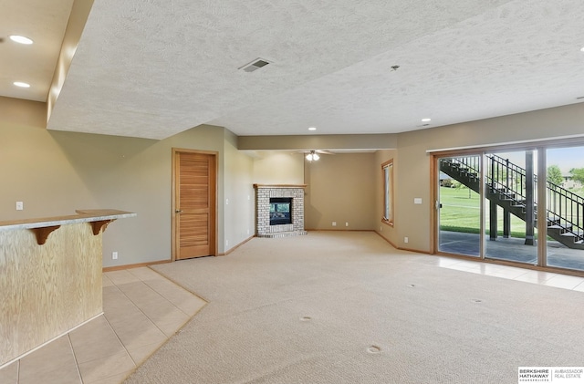 211 Longwood Dr, Papillion, NE 68133 - unfurnished living room featuring baseboards, light tile patterned flooring, a fireplace, recessed lighting, and light carpet