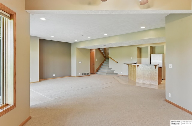 211 Longwood Dr, Papillion, NE 68133 - unfurnished living room featuring light carpet, baseboards, stairway, and recessed lighting