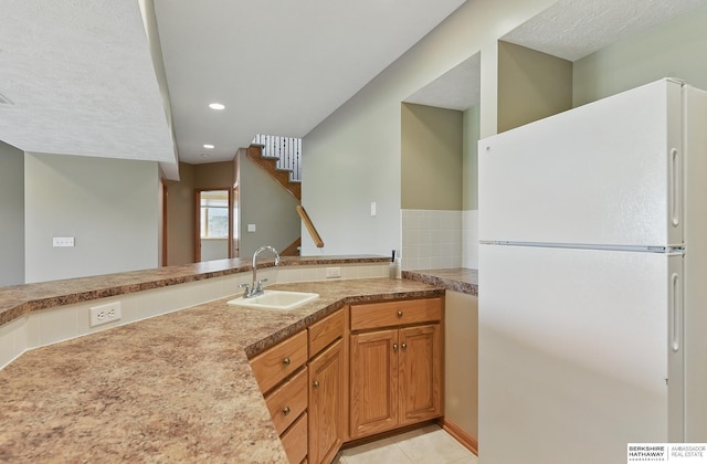 211 Longwood Dr, Papillion, NE 68133 - kitchen featuring freestanding refrigerator, a sink, recessed lighting, light countertops, and light tile patterned floors