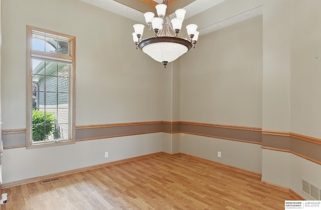 211 Longwood Dr, Papillion, NE 68133 - empty room with plenty of natural light, wood finished floors, a chandelier, and baseboards
