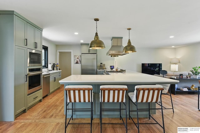 317 N 96th St, Omaha, NE 68114 - kitchen featuring built in appliances, wall chimney range hood, open floor plan, light countertops, and a kitchen bar