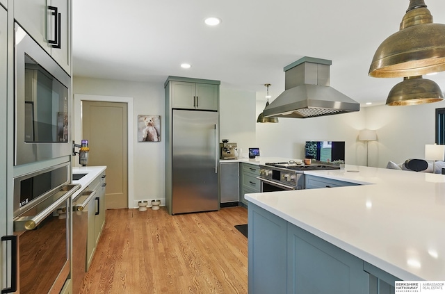 317 N 96th St, Omaha, NE 68114 - kitchen with built in appliances, island range hood, light countertops, light wood-style flooring, and recessed lighting