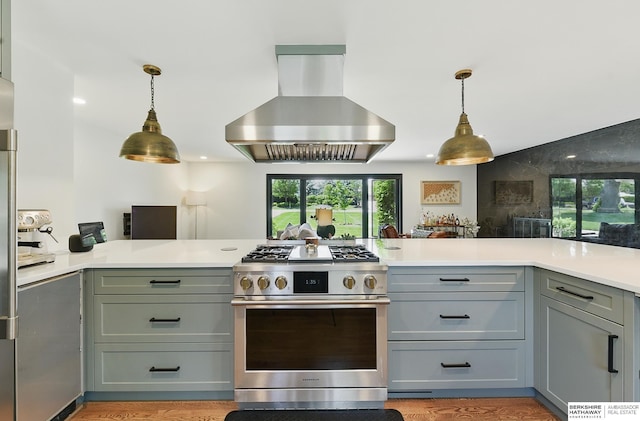 317 N 96th St, Omaha, NE 68114 - kitchen with high end stainless steel range oven, range hood, gray cabinetry, light countertops, and hanging light fixtures
