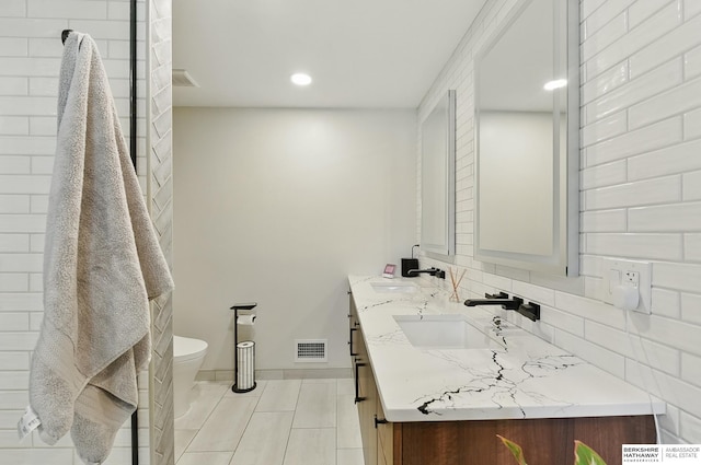317 N 96th St, Omaha, NE 68114 - bathroom with toilet, double vanity, tile patterned floors, baseboards, and recessed lighting