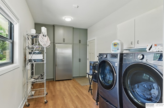 317 N 96th St, Omaha, NE 68114 - washroom with cabinet space, washing machine and clothes dryer, and light wood-type flooring