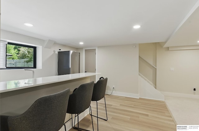 317 N 96th St, Omaha, NE 68114 - bar with light wood finished floors, recessed lighting, baseboards, and stairway