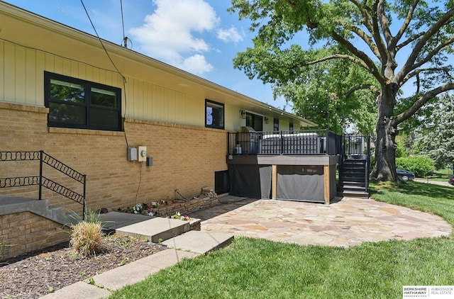 317 N 96th St, Omaha, NE 68114 - view of side of home with stairway, brick siding, a patio, a deck, and a lawn