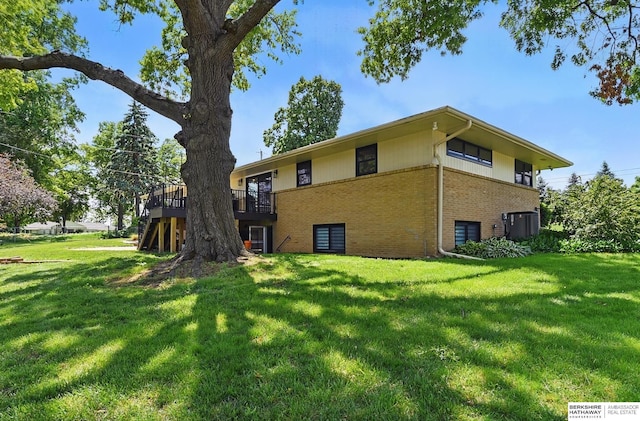 317 N 96th St, Omaha, NE 68114 - back of property featuring brick siding, a yard, and a deck
