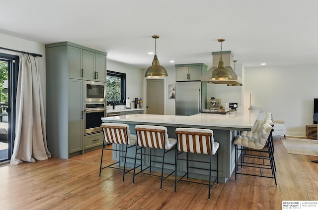 317 N 96th St, Omaha, NE 68114 - kitchen with stainless steel appliances, exhaust hood, plenty of natural light, light countertops, and recessed lighting