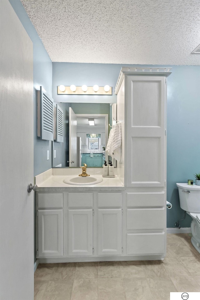 3400 Glenhaven Pl, Lincoln, NE 68506 - bathroom with a textured ceiling, toilet, and vanity