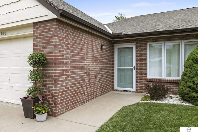 3400 Glenhaven Pl, Lincoln, NE 68506 - property entrance with brick siding, a garage, and a shingled roof