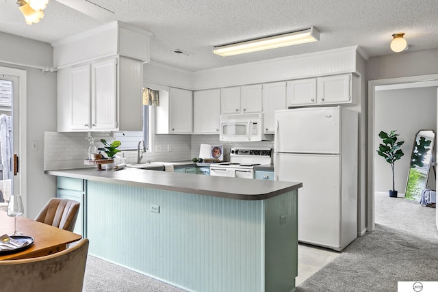 3400 Glenhaven Pl, Lincoln, NE 68506 - kitchen with white appliances, a peninsula, healthy amount of natural light, backsplash, and a textured ceiling