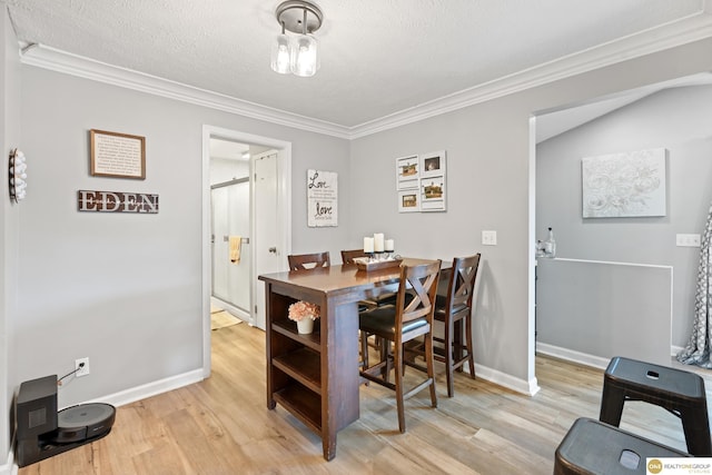 6458 Decatur St, Omaha, NE 68104 - dining space featuring wood finished floors, crown molding, baseboards, and a textured ceiling