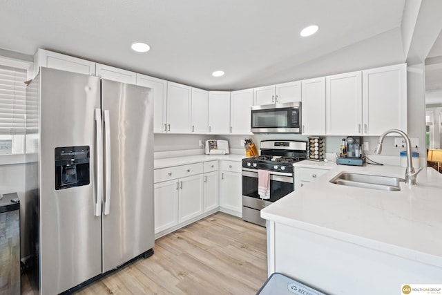 6458 Decatur St, Omaha, NE 68104 - kitchen featuring stainless steel appliances, a sink, light countertops, white cabinets, and light wood-style flooring