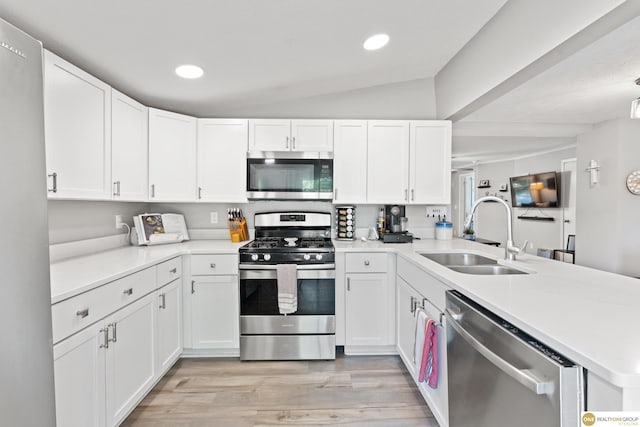 6458 Decatur St, Omaha, NE 68104 - kitchen with stainless steel appliances, a sink, a peninsula, light wood finished floors, and recessed lighting