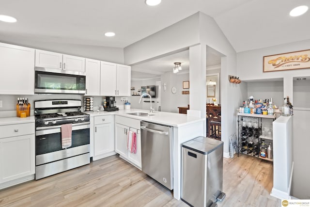 6458 Decatur St, Omaha, NE 68104 - kitchen featuring appliances with stainless steel finishes, a sink, white cabinets, light wood-style floors, and light countertops