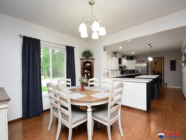 105 Nebraska St, Murdock, NE 68407 - dining room with dark wood-type flooring, a chandelier, and baseboards