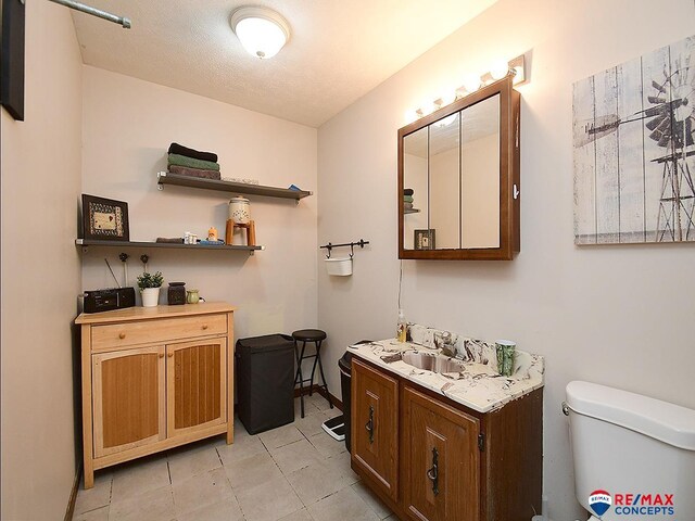 105 Nebraska St, Murdock, NE 68407 - bathroom with toilet, vanity, tile patterned flooring, and baseboards