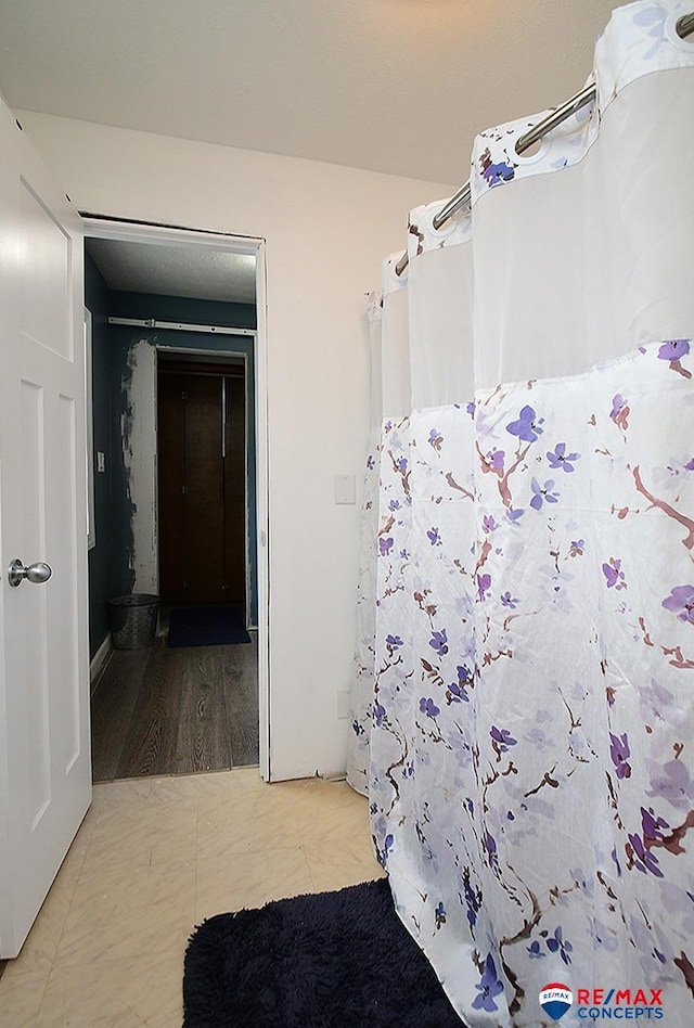 105 Nebraska St, Murdock, NE 68407 - bathroom featuring curtained shower and wood finished floors