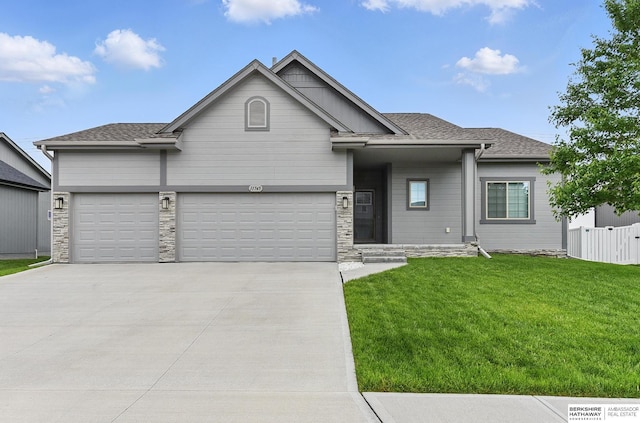 11745 S 113th St, Papillion, NE 68046 - view of front of house featuring concrete driveway, an attached garage, roof with shingles, and stone siding