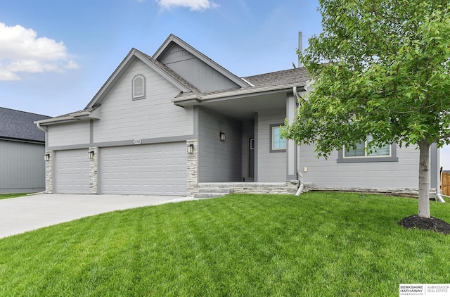 11745 S 113th St, Papillion, NE 68046 - view of front of home with a front lawn, driveway, a garage, and stone siding