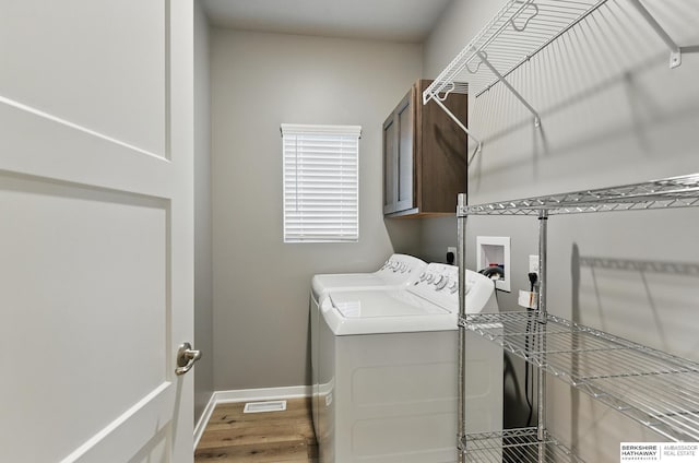 11745 S 113th St, Papillion, NE 68046 - washroom featuring washing machine and dryer, cabinet space, wood finished floors, and baseboards